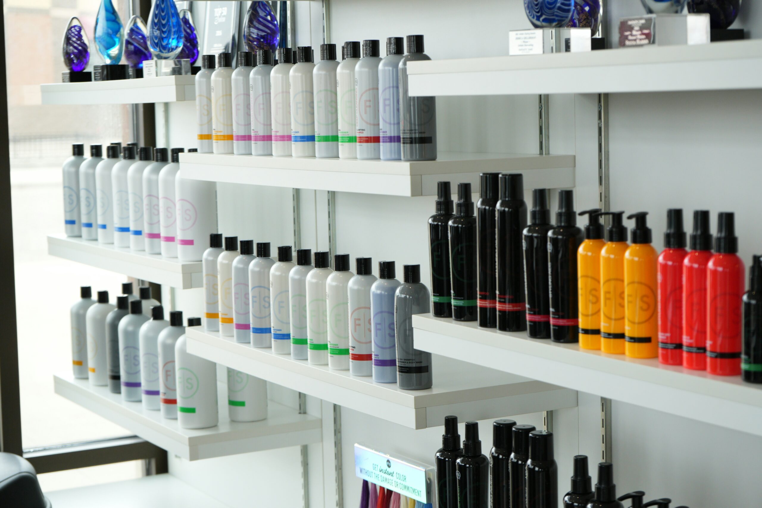 A shelf filled with conventional beauty products containing harsh chemicals