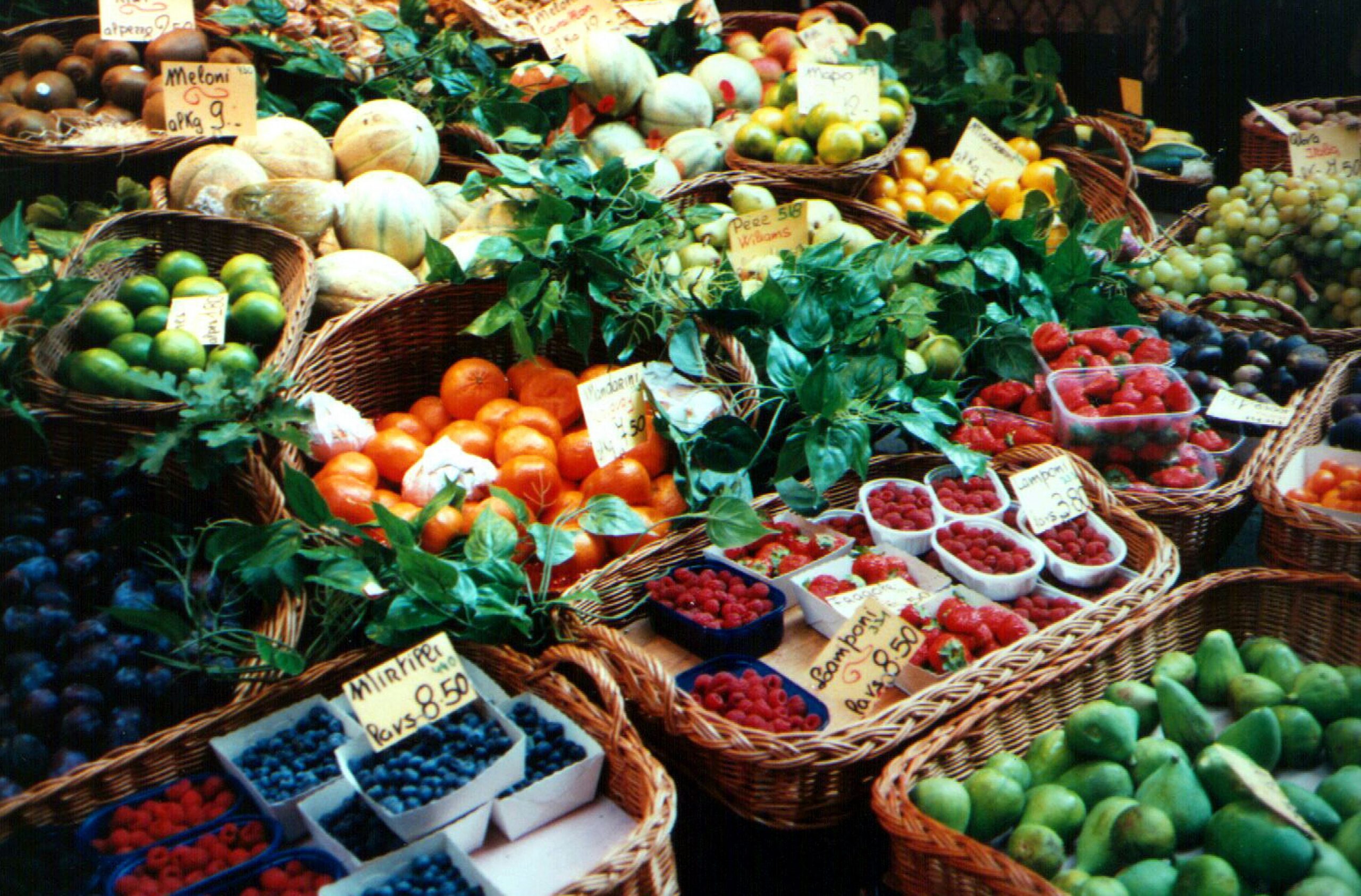A shopping cart filled with organic fruits and vegetables