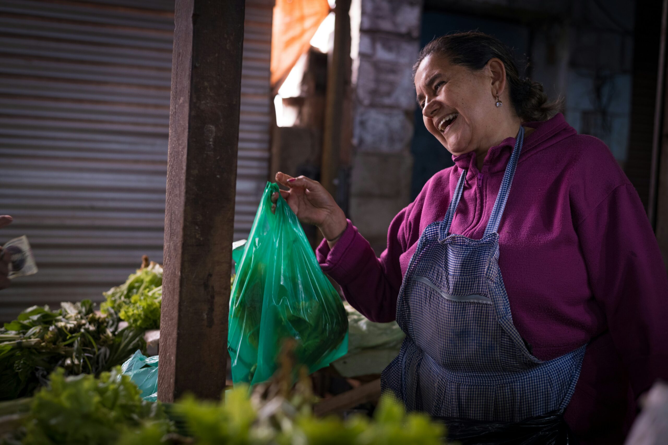 A woman holding a bowl of fresh organic vegetables