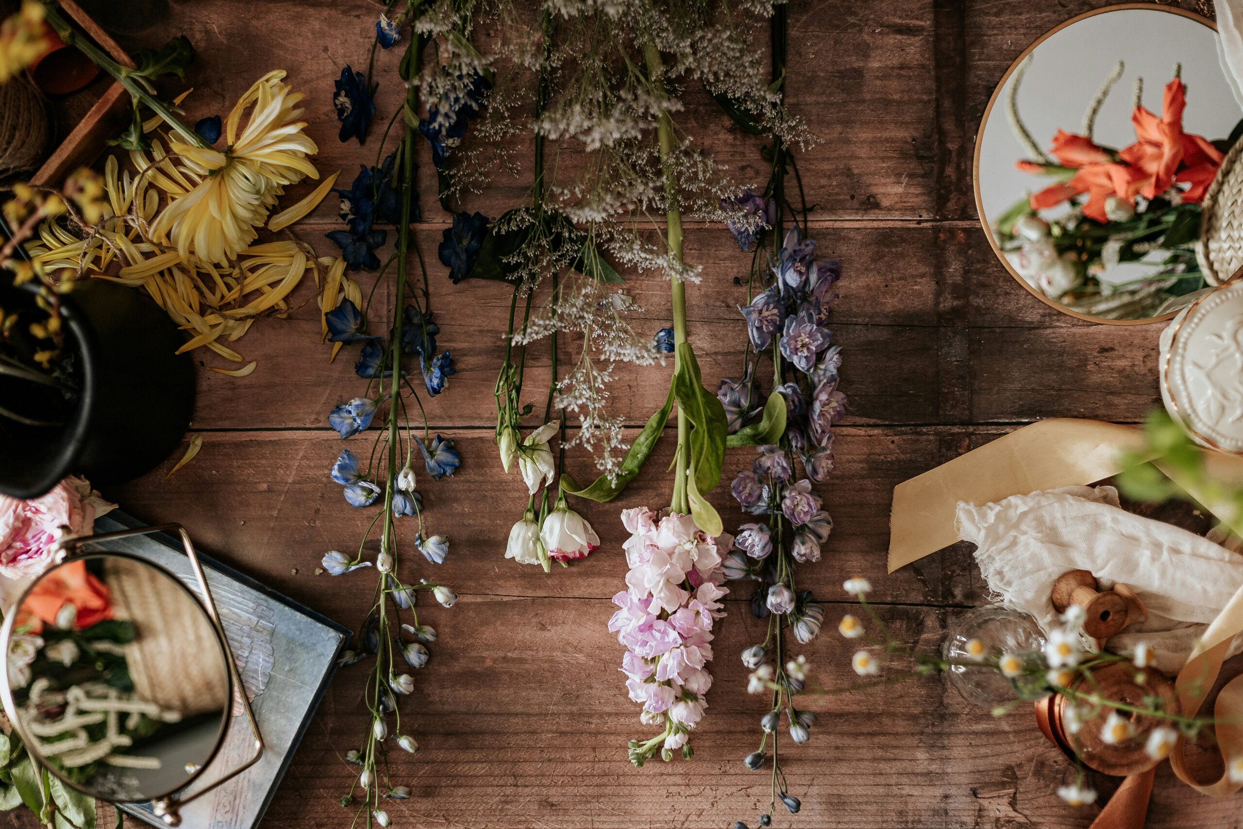 Lush cosmetics products displayed on wooden table near fresh lavender sprigs
