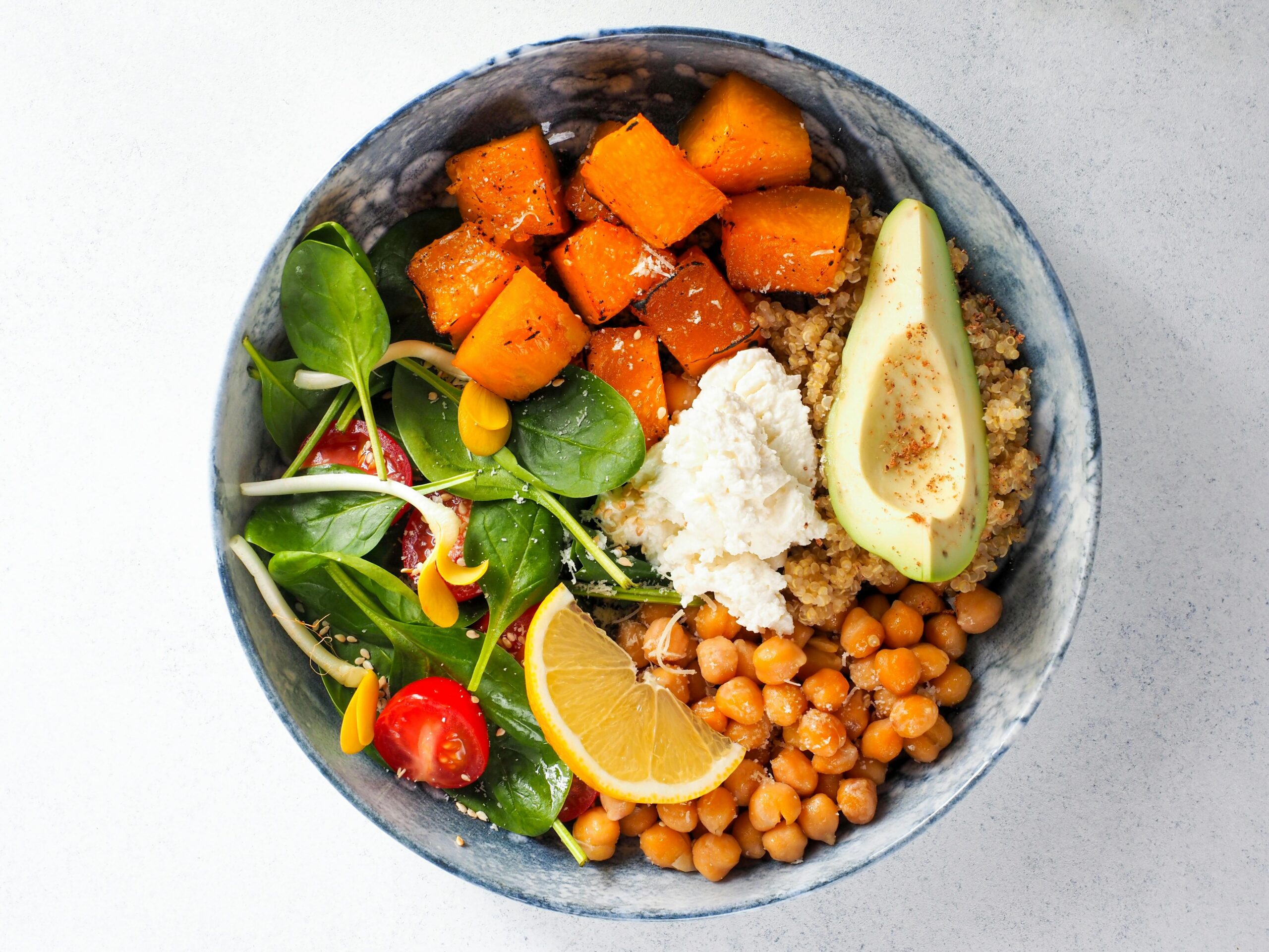 Three vibrant plant-based meals including quinoa bowls, roasted sweet potatoes, and chickpea curry.