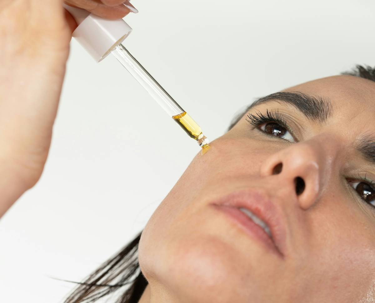 a woman getting her eyebrows done with a syring