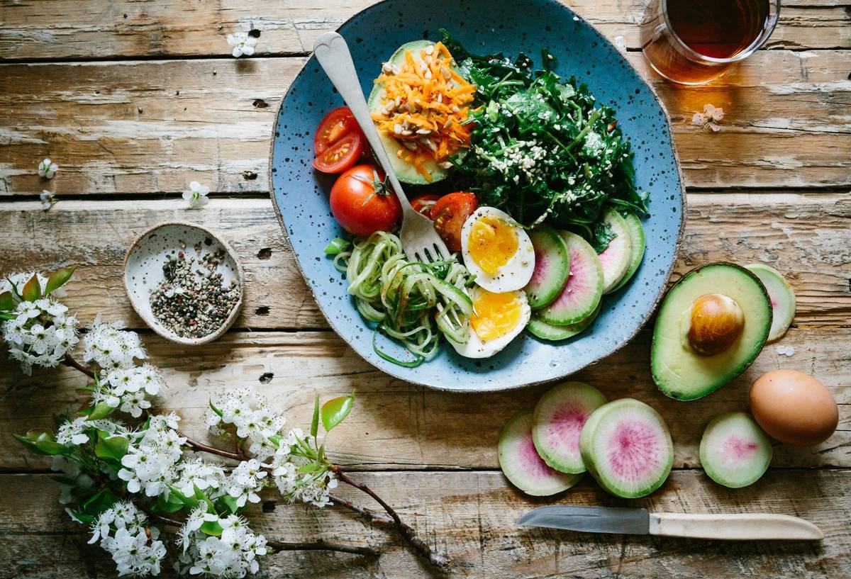 Woman preparing fresh organic vegetables for nutrition eating vegetable routine focused on skin health